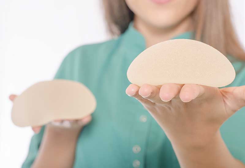 nurse holding breast implant types